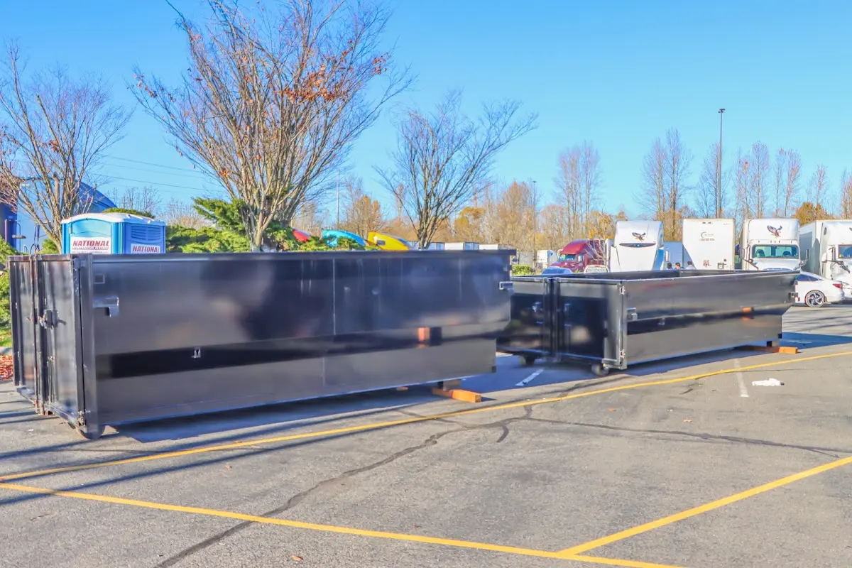 Professional dumpster rental service with roll-off container on residential driveway in Rock Springs